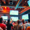 Engaged fans watching live sports broadcasts on 토토스토리 in a lively sports bar.