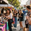 Engaging urban shopping scene with friends exploring 레플리카 fashion items in a vibrant market setting.