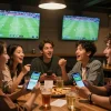 Cakhia TV users enjoying a lively sports betting experience with friends during a football match.