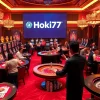 An enthusiastic gambler wins big at Hoki77 heylink, surrounded by luxury casino tables and glittering slot machines.