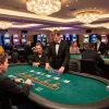 Players at fly88 blackjack tables enjoying an engaging gaming experience in a vibrant casino atmosphere.