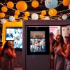 Guests enjoying a photo booth Chicago experience with vibrant props and festive decor.