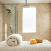 Transform your space with elegant showers Australia, showcasing a modern rain shower and luxurious bathroom design.