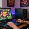 player enjoying slot depo 1000 game on a laptop in a vibrant gaming space