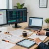 Asset tracing analysis in a professional office with documents and dual monitors.