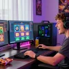 Exciting online gaming experience with koitoto slot games on multiple monitors and vibrant decor